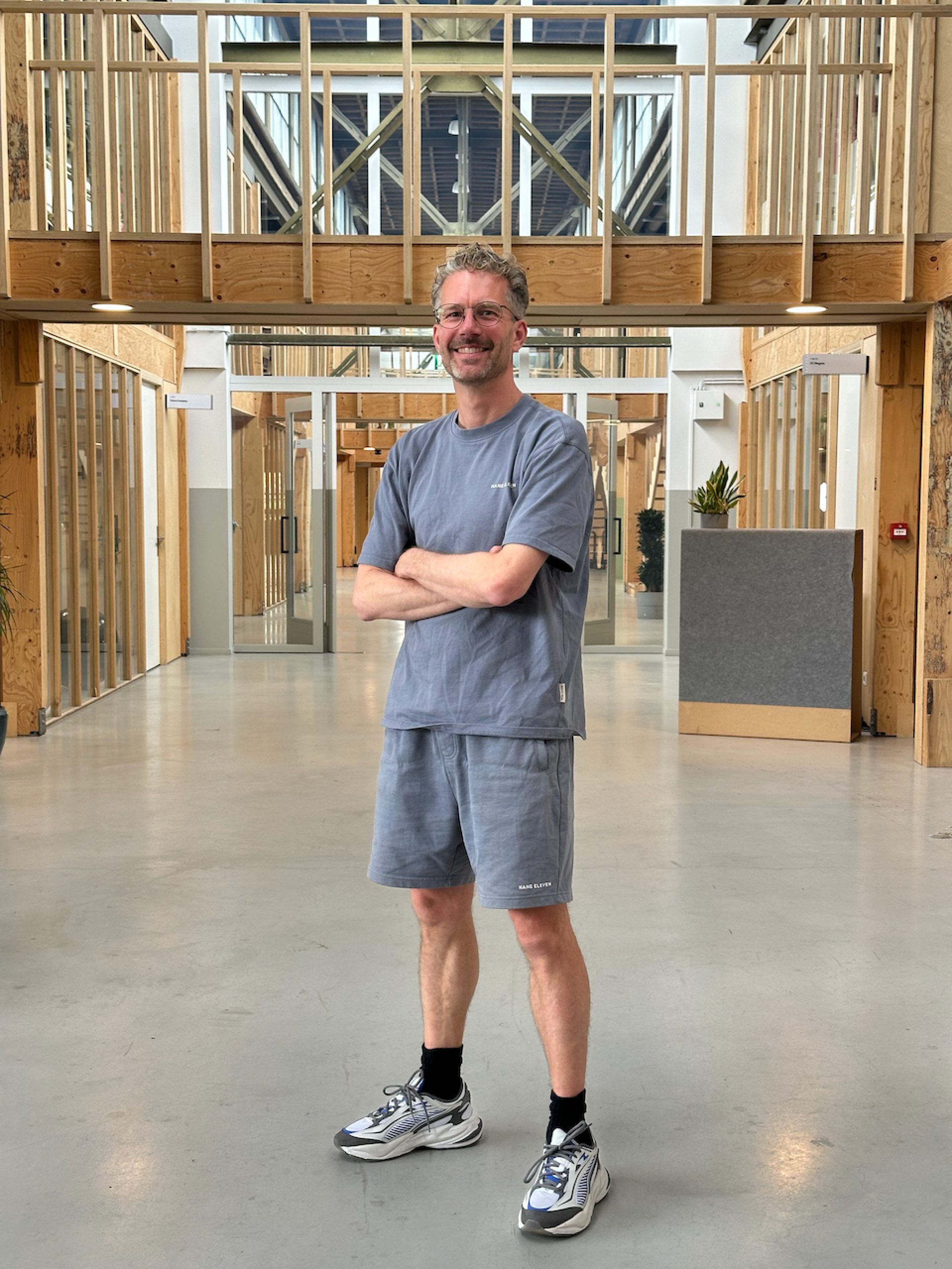 Niels de Feyter standing in a timber-framed office building.