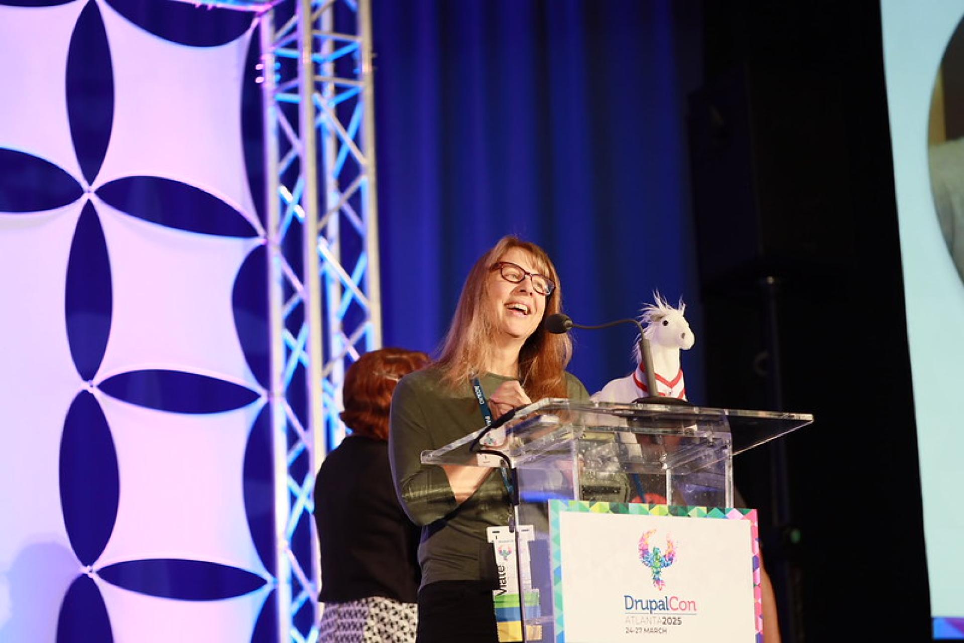 Kristen Pol speaking during the 2025 Aaron Winborn Award presentation at DrupalCon Atlanta.