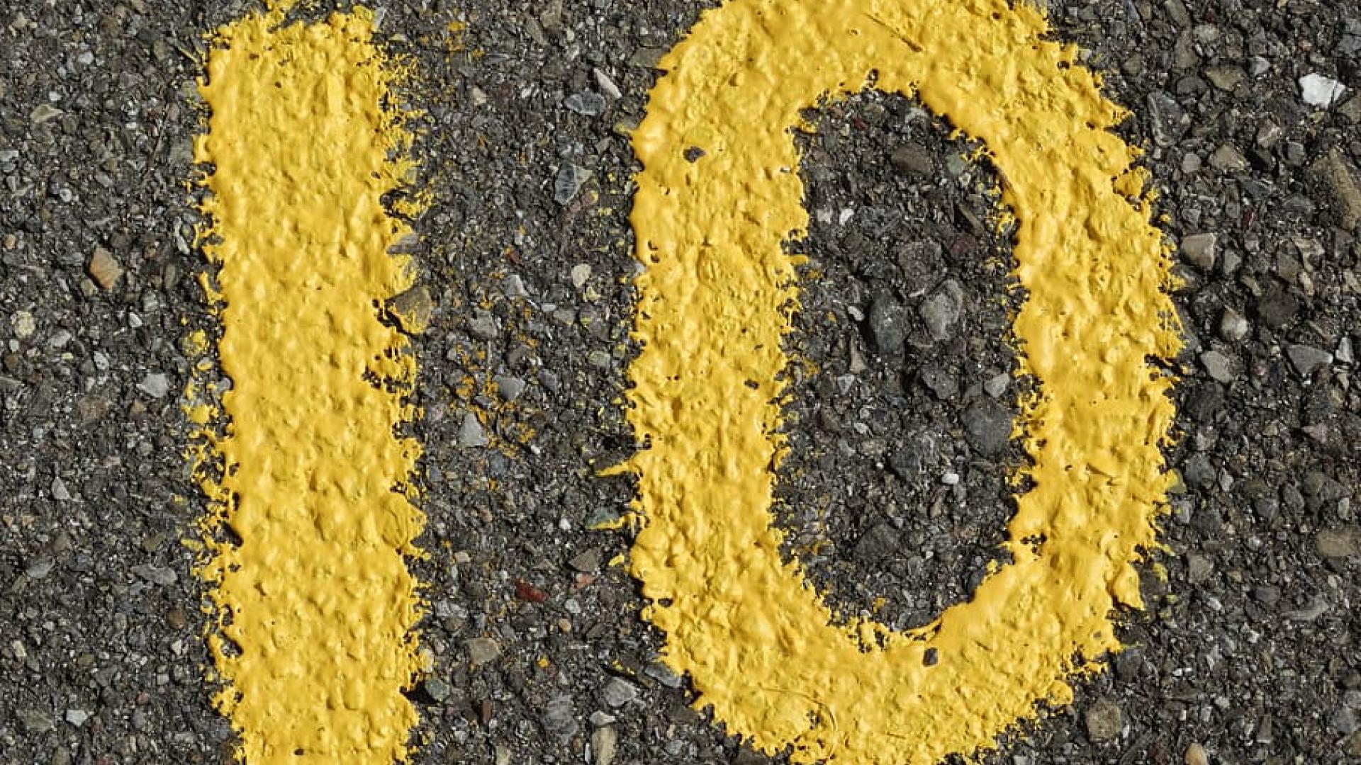Number 10 drawn with yellow paint on gravel road 