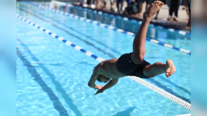 A man diving into a swimming pool