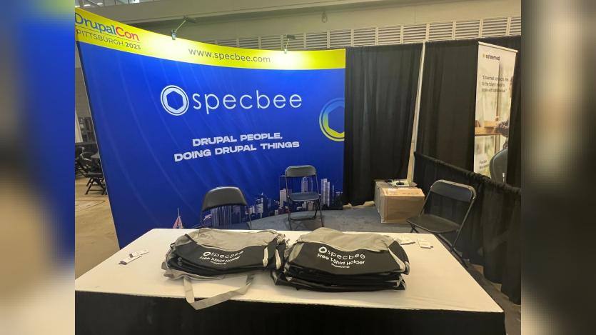 Specbee's Booth at DrupalCon Pittsburgh 2023 with Free GymBags to Distribute as Drupal Swag