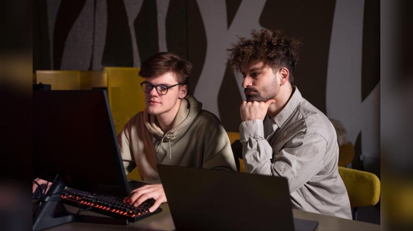 two men staring at a system