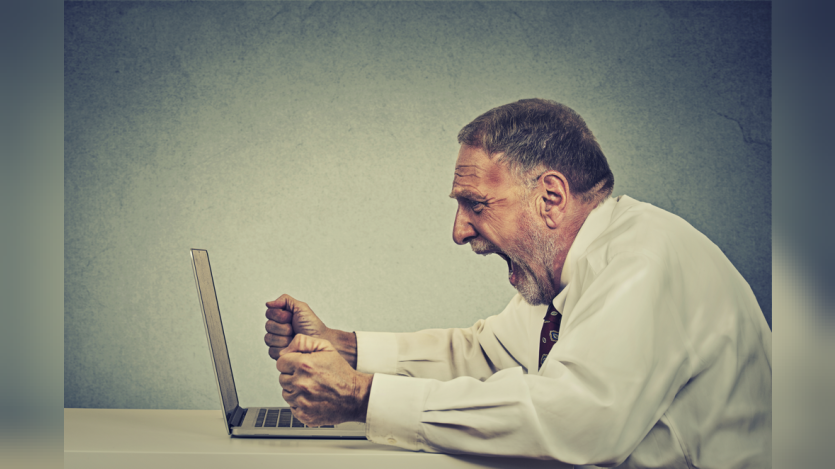 man screaming at the laptop