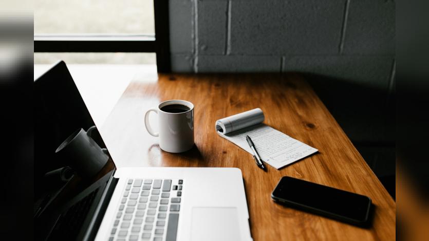 laptop, coffee cup and open book