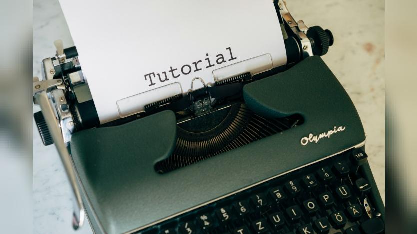 Tutorial written on a piece of paper lodged in a typewriter
