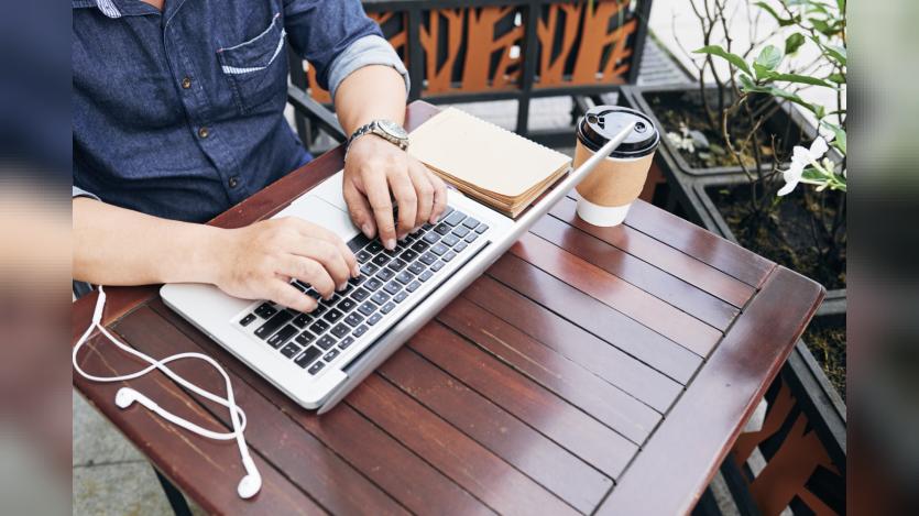 man coding on laptop