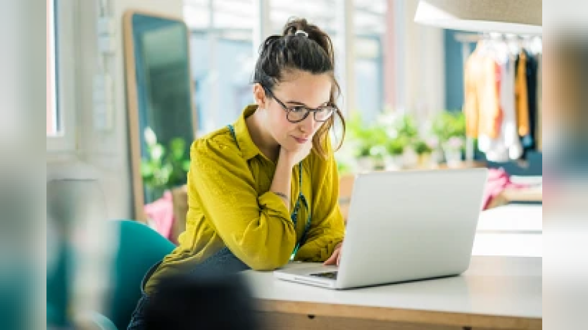 woman reading from her laptop