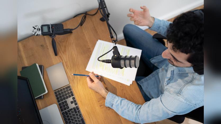 Man with microphone and headphones running a podcast in the studio