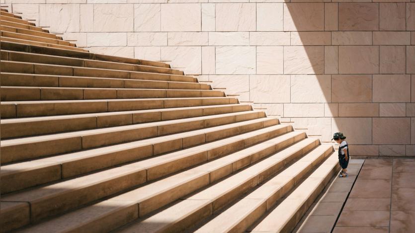 a child standing in front of the staircase