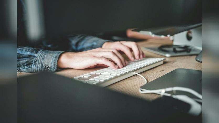 Person typing on keyboard