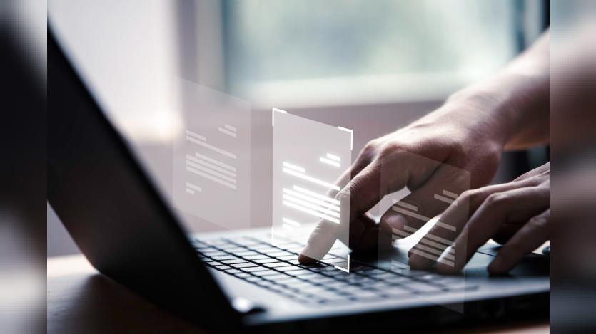 Hand using laptop computer with virtual screen and document for online approve paperless quality assurance and ERP management concept
