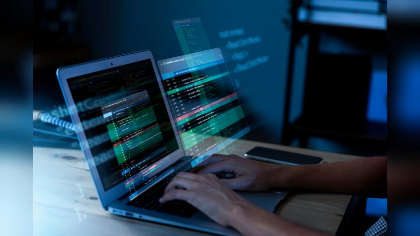 Programming background with person working with codes on computer