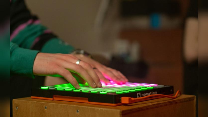 some guy typing on an illuminated keyboard
