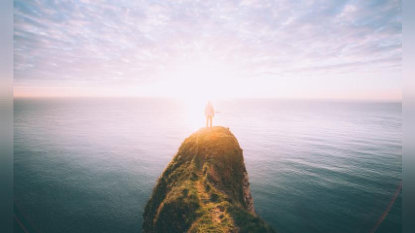 man standing on a cliff