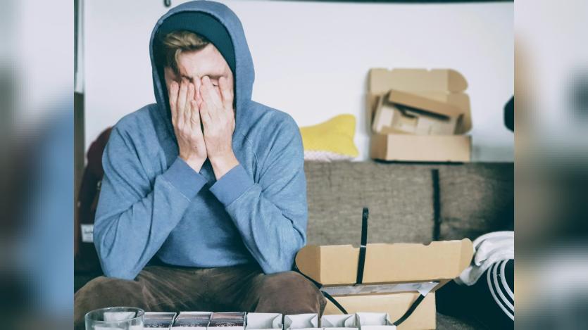 stressed man covering his face
