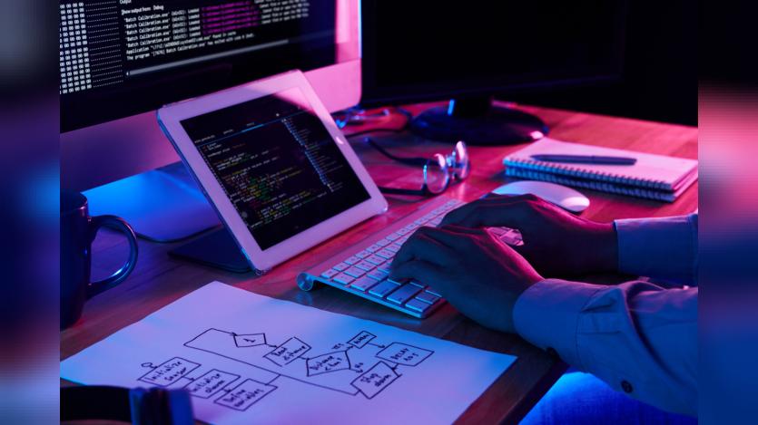 Close-up image of programer working at his desk in office