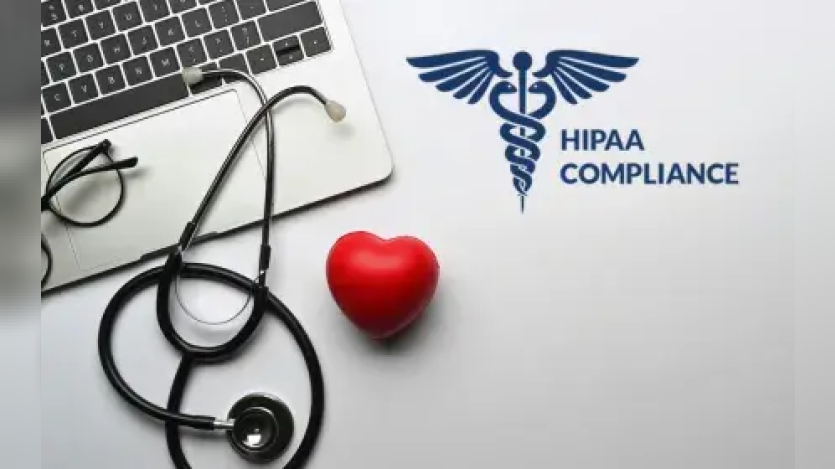 A laptop, stethescope, a red heart and HIPAA Compliance