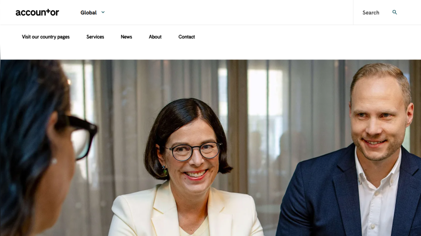 Accountor website header with navigation and a hero image showing three professionals in a meeting.