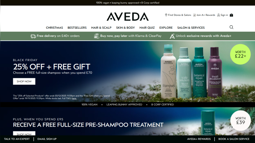 Aveda website homepage showing Black Friday 25% off plus free gift shampoo offer and free pre-shampoo treatment with spend thresholds