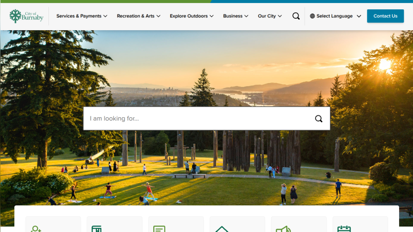 University website homepage with navigation menu and search bar over a scenic campus landscape at sunset