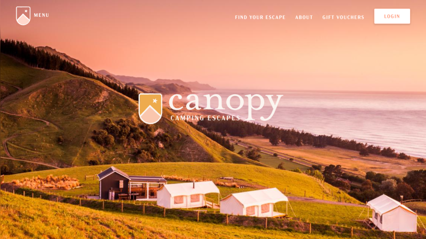 Camping escapes website with scenic coastal hillside and tents under a sunset sky, navigation links and login button