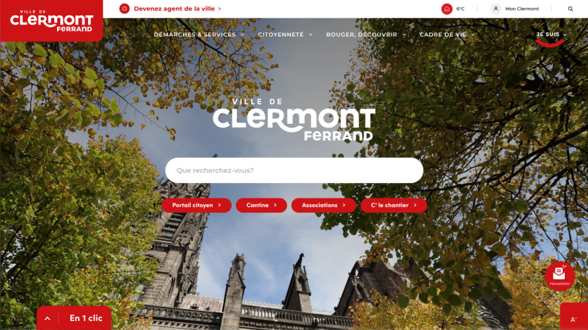 City of Clermont-Ferrand website homepage with navigation menu, search bar, and autumn trees framing cathedral towers