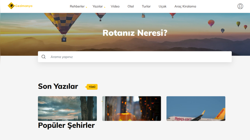 Travel website homepage with hot air balloon hero image, search bar, and sections for recent posts and popular cities