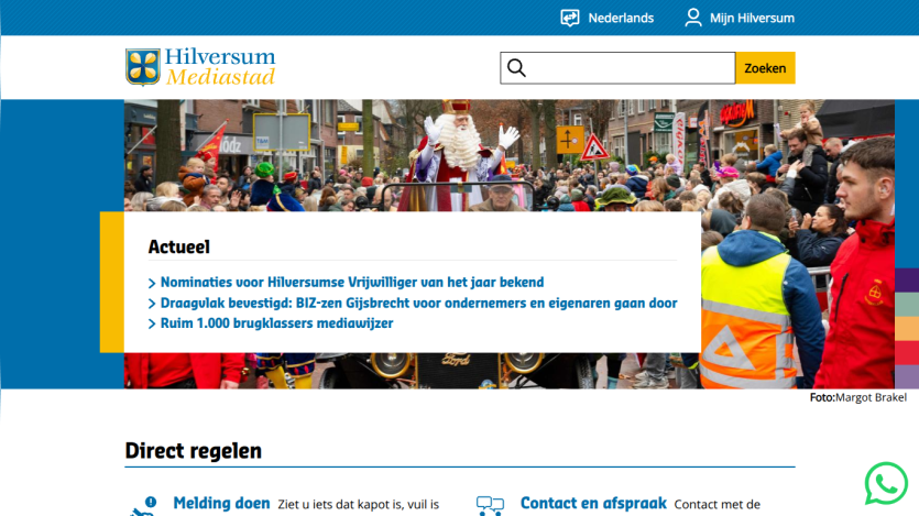 Hilversum Mediastad website with news headlines and a festive parade image in the hero section