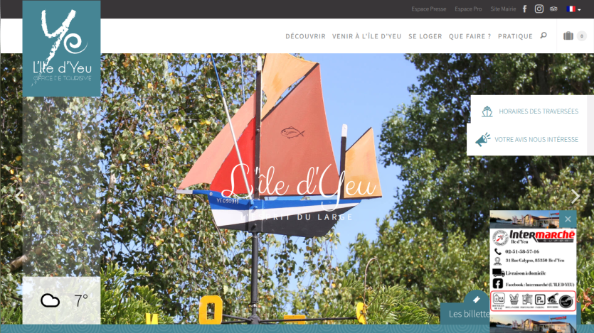 Tourism office website for L'île d'Yeu with navigation menu and a colorful sailboat sculpture in the hero section