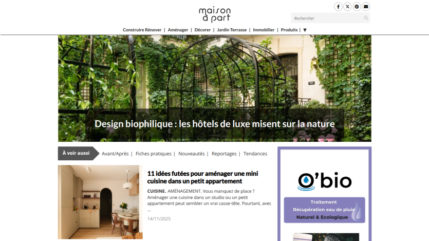 Website homepage featuring a biophilic design hotel with a large green plant-covered glass ceiling and article headline about creating a cozy kitchen corner