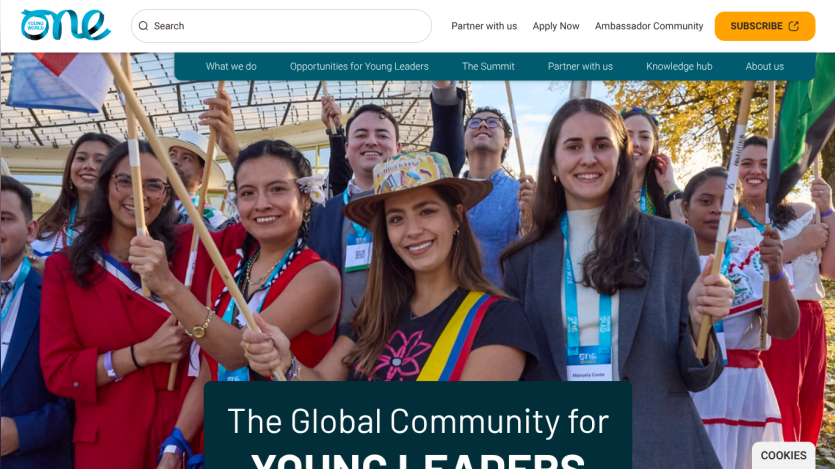 The Global Community for Young Leaders with diverse group of smiling participants holding flags.
