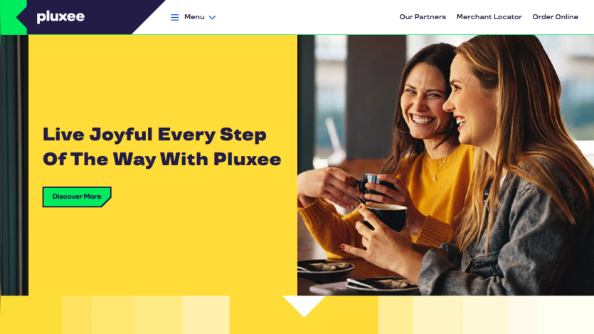 Pluxee homepage with tagline 'Live Joyful Every Step Of The Way With Pluxee' and smiling women enjoying coffee