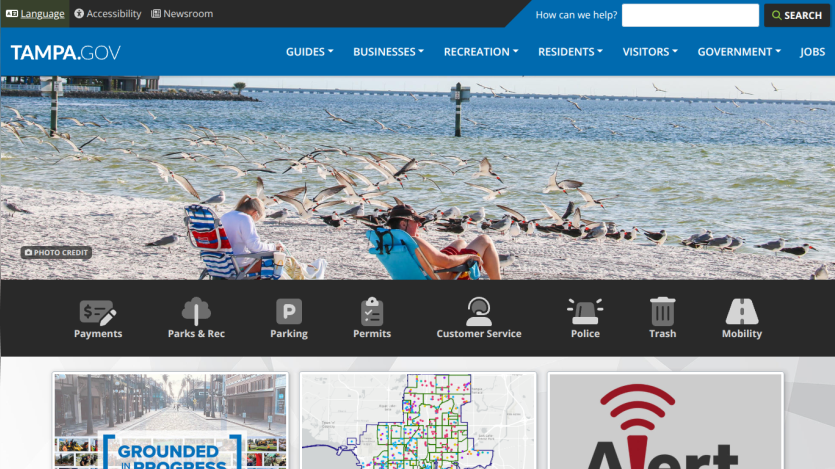Tampa Bay beach scene with people relaxing and a navigation bar above.