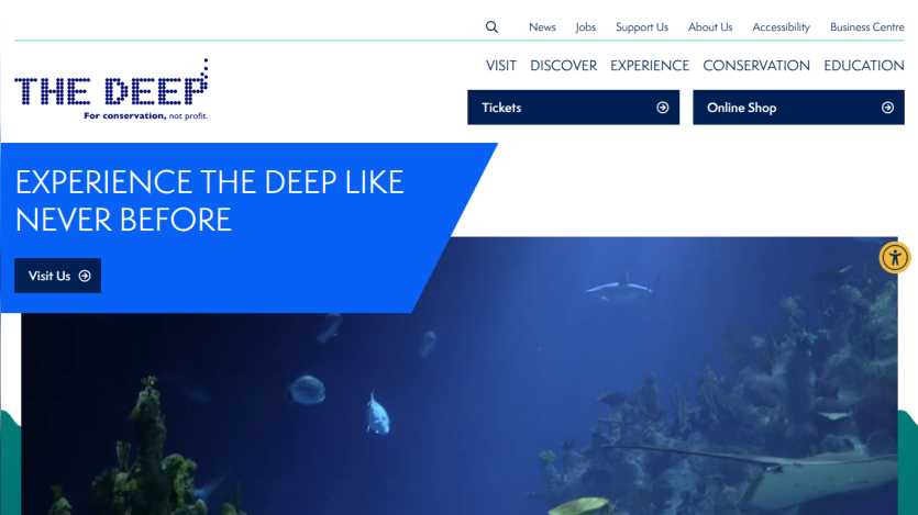 The Deep aquarium homepage with navigation links, call to action to visit, and underwater marine life hero image