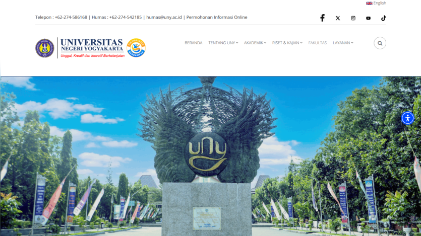 University campus entrance with a prominent logo and banners.