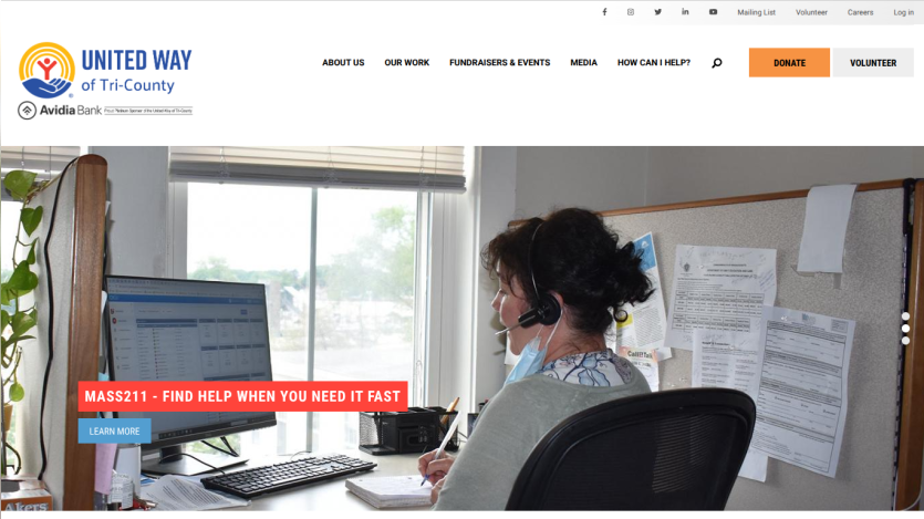 Homepage with a blue header featuring navigation links and a hero section showcasing a laptop and smartphone with app interface