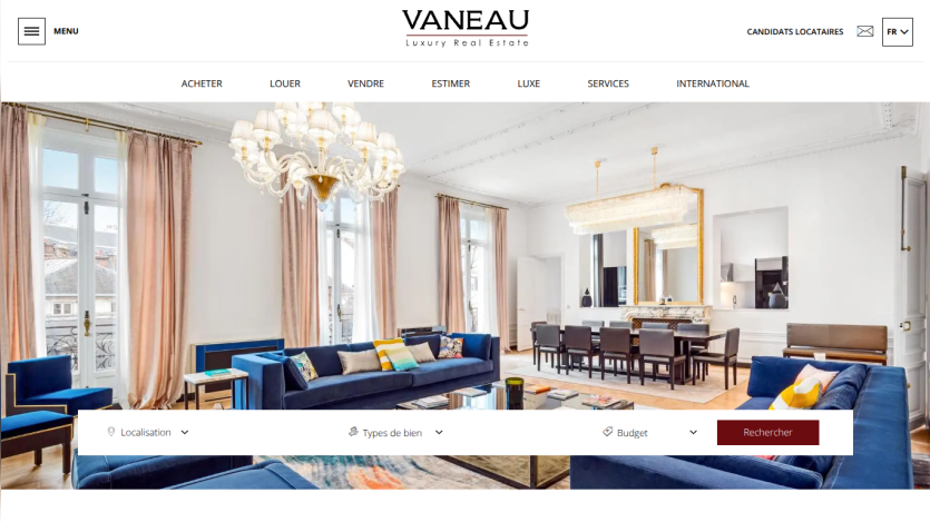 Elegant living room showcasing blue sofas and a chandelier, with navigation options above.