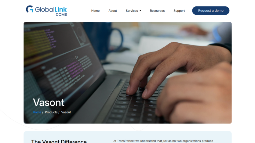 Vasant product page showcasing a hand typing on a laptop with coding on the screen.