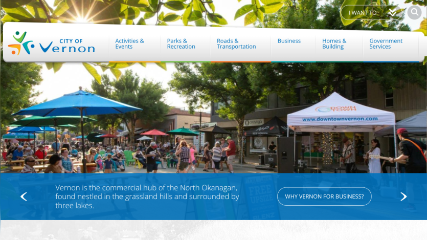 City of Vernon website with navigation menu and a community event scene under umbrellas
