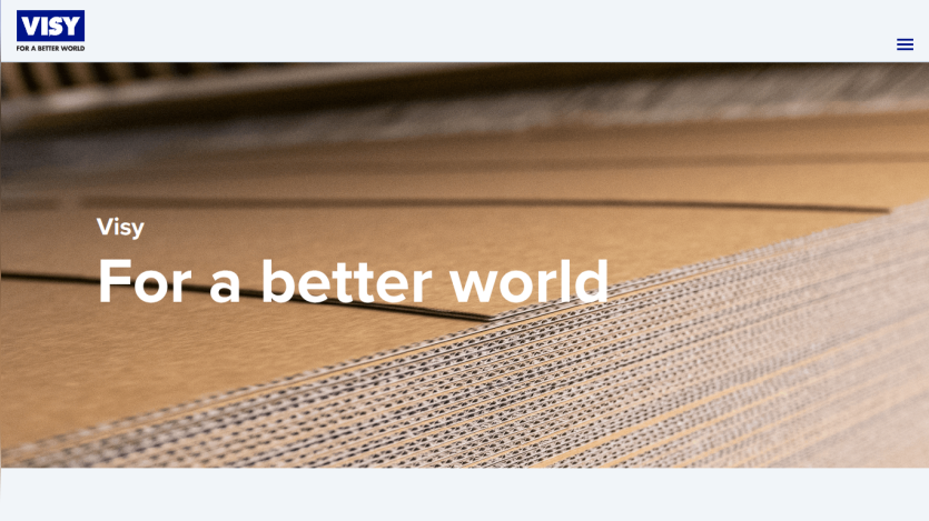 Visy website hero section with slogan 'For a better world' over a close-up of stacked cardboard sheets
