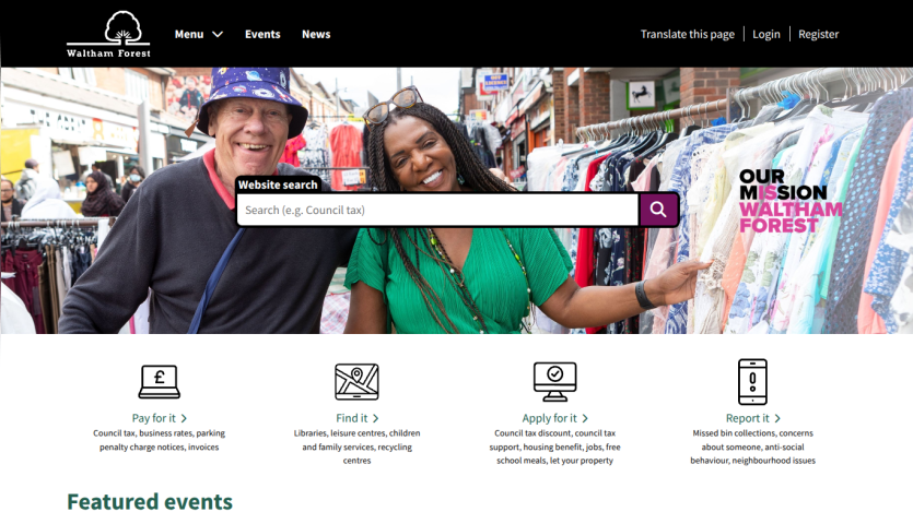 Homepage featuring a search bar and two smiling individuals in a market setting.