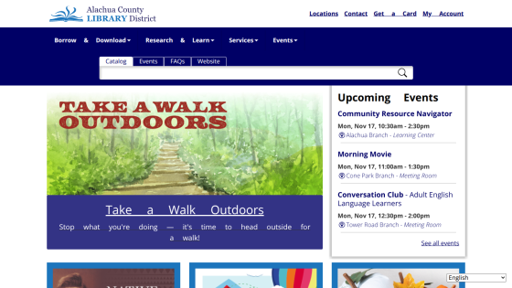 Alachua County Library District homepage with navigation, search bar, hero image promoting outdoor walks, and upcoming events listing.