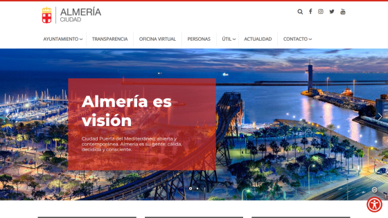 Almería city website with navigation menu and hero section featuring a nighttime harbor view and slogan 'Almería es visión'
