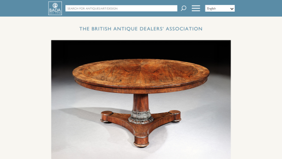 British Antique Dealers' Association homepage with search bar and a round wooden antique table featured