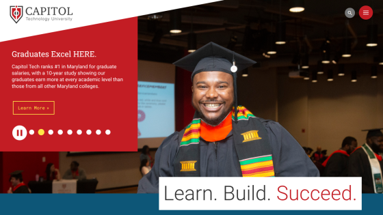 Capitol Tech's homepage hero with a smiling graduate in cap and gown, promoting graduate success and a call to action button.