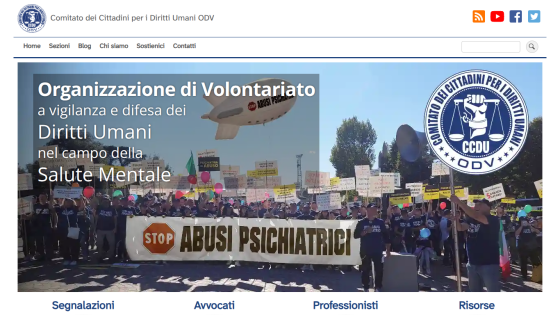 Homepage of an organization advocating for human rights in mental health, featuring a protest image.