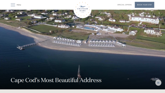 Aerial view of a beach resort with text 'Cape Cod's Most Beautiful Address' and navigation menu with booking option