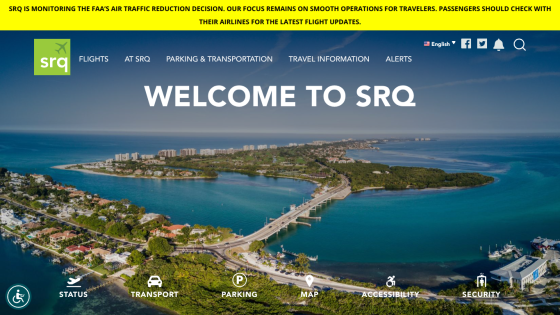 Airport website with navigation links and a welcome message over an aerial coastal view