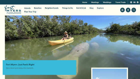 Fort Myers tourism site with navigation and hero image of a woman kayaking near a manatee in calm water