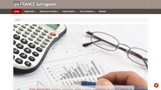 Calculator and glasses on a financial report with graphs and charts.